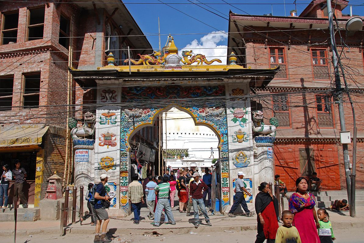 Kathmandu Boudhanath 03 Boudhanath Entrance The magnificent Boudhanath Stupa near Kathmandu is approached on the south side of the stupa under an arched gateway, a new addition built in traditional Tibetan monastic design with eight auspicious symbols on two sides of the gate and some miniature chaityas on the top.